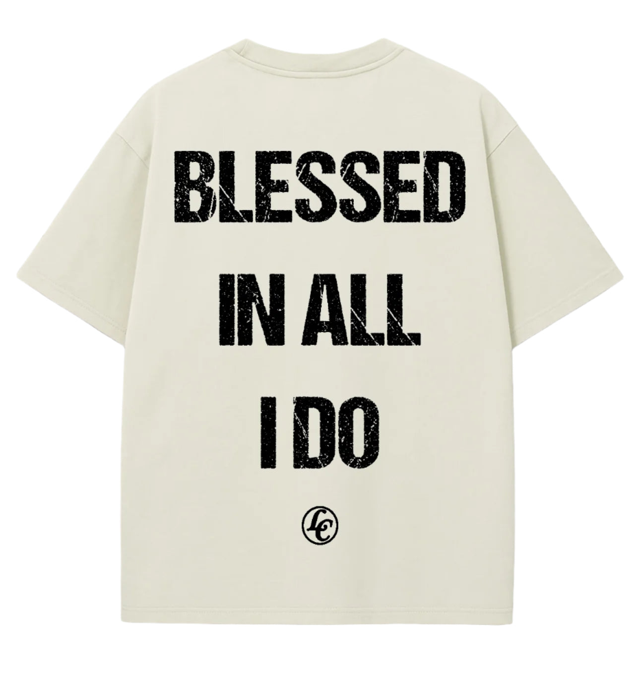 Beige t-shirt with 'Blessed in all I do' text on a gray surface