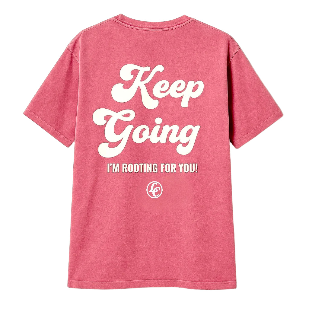 Pink t-shirt with 'Keep Going I'm Rooting For You!' text on the back against a beige background