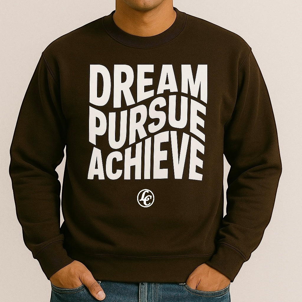 Person wearing a brown sweatshirt with 'Dream Pursue Achieve' text on a beige background