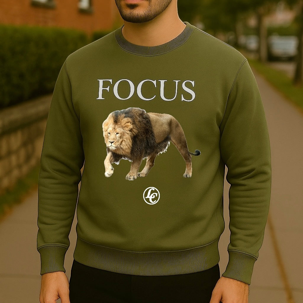 Person wearing a green sweatshirt with a lion graphic and 'FOCUS' text.