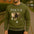Person wearing a green sweatshirt with a lion graphic and 'FOCUS' text.
