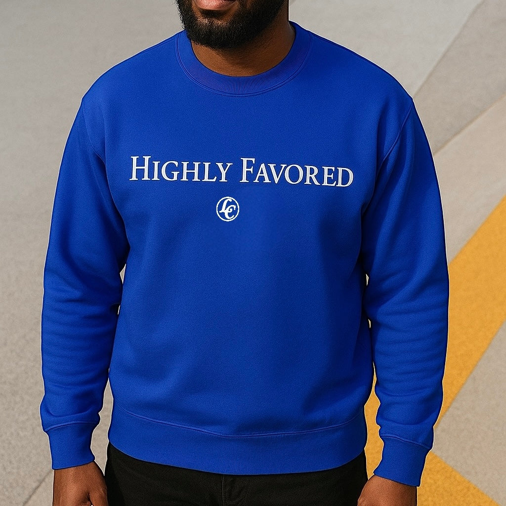 Person wearing a blue sweatshirt with 'HIGHLY FAVORED' text on a neutral background