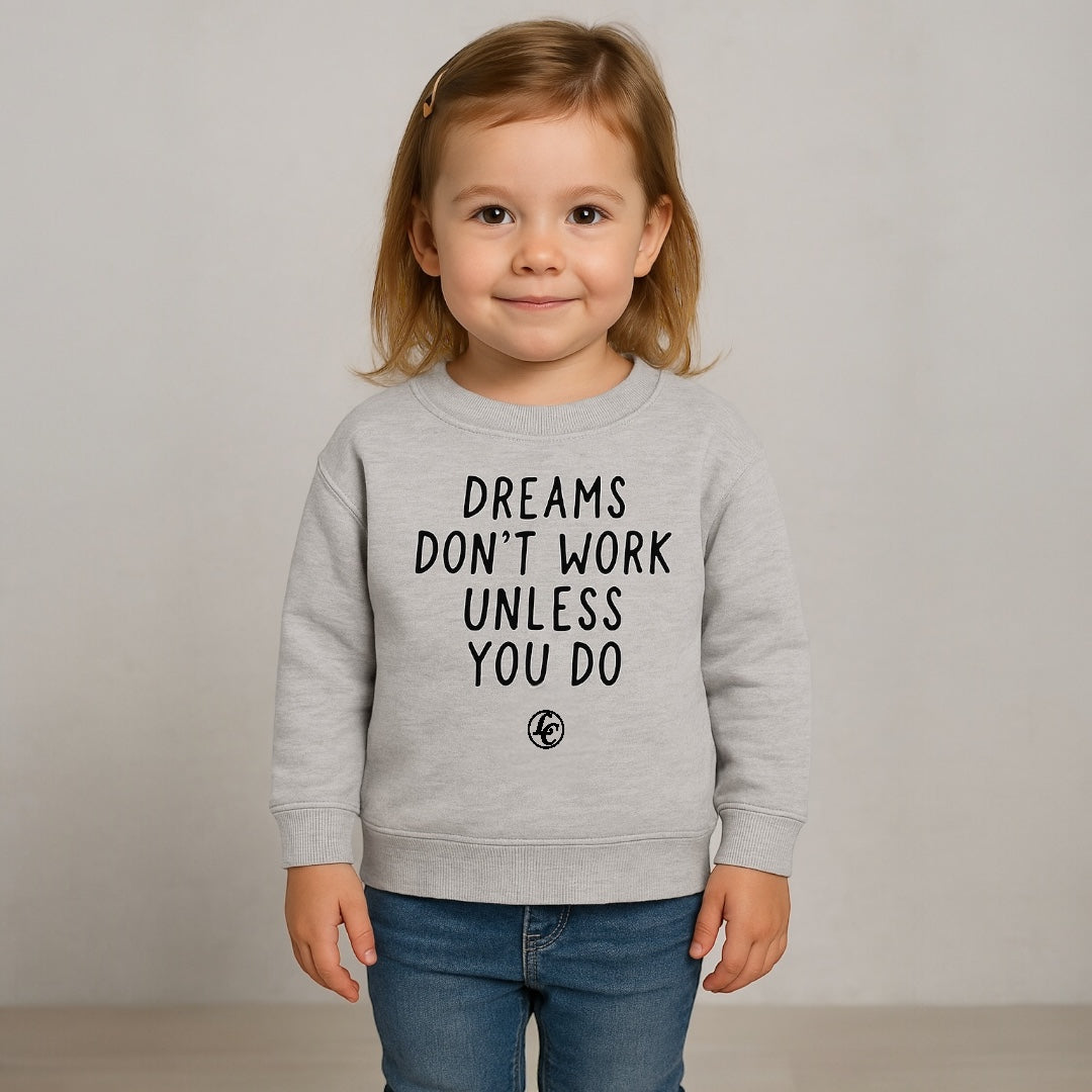 Child wearing a gray sweatshirt with motivational text on a plain background