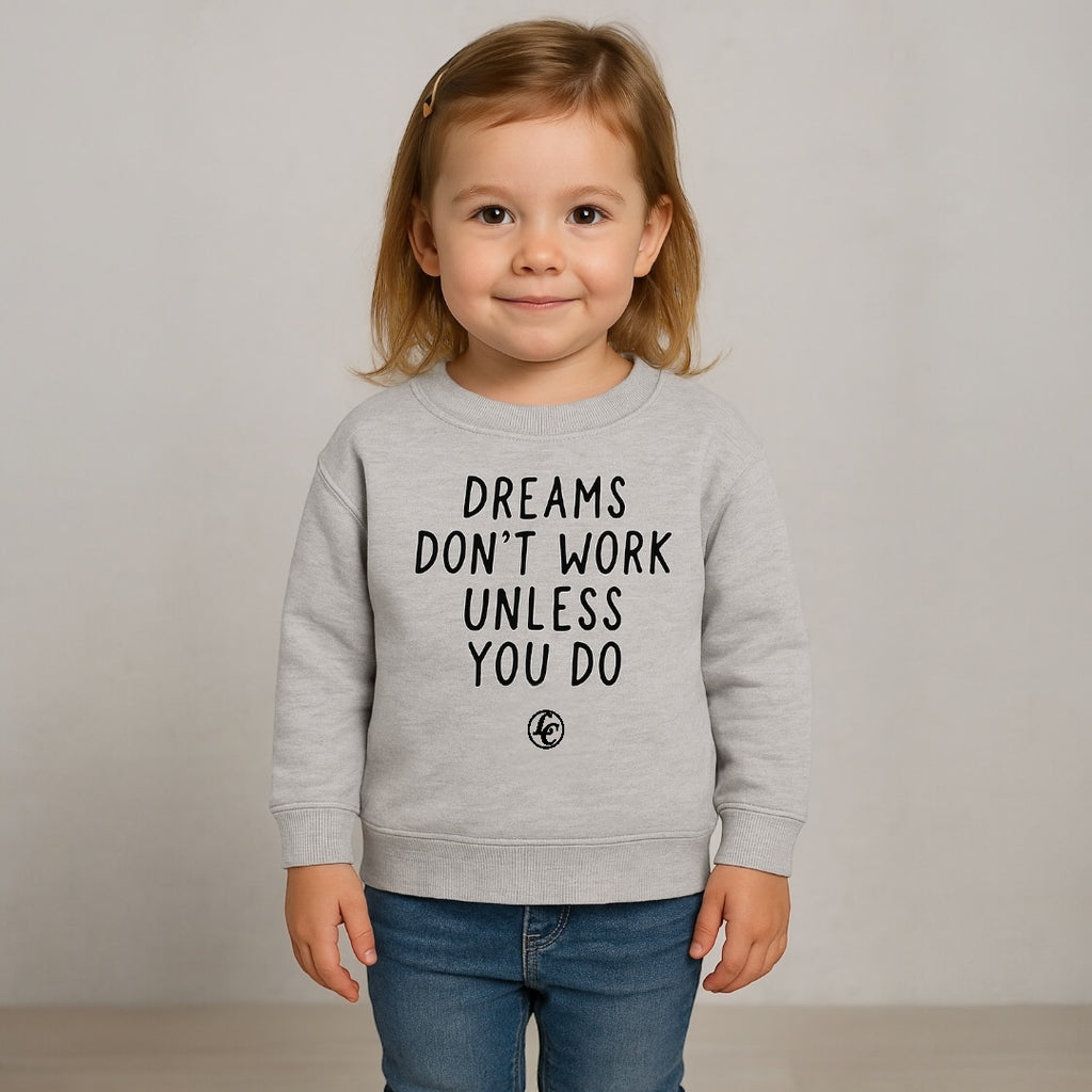 Child wearing a gray sweatshirt with motivational text on a plain background