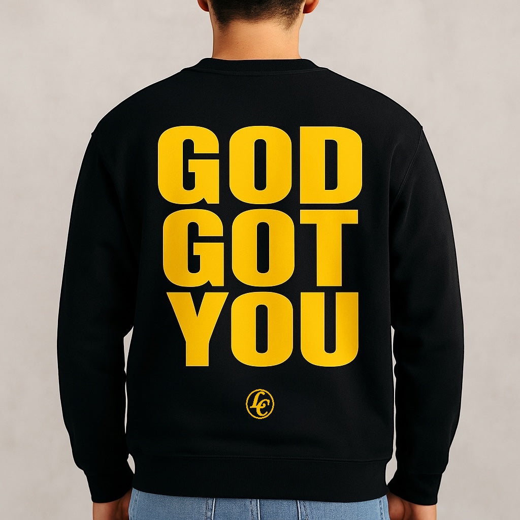 Black sweatshirt with 'GOD GOT YOU' in yellow on the back, worn by a person.
