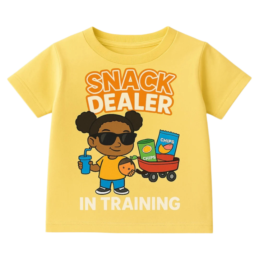 Yellow t-shirt with a cartoon character and text 'Snack Dealer in Training' on a gray background
