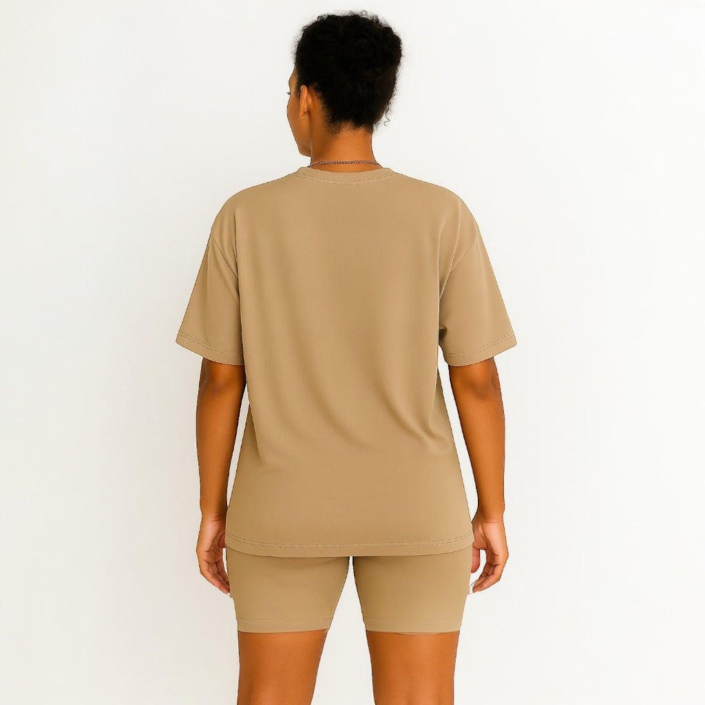 Person wearing a beige t-shirt and shorts set on a white background