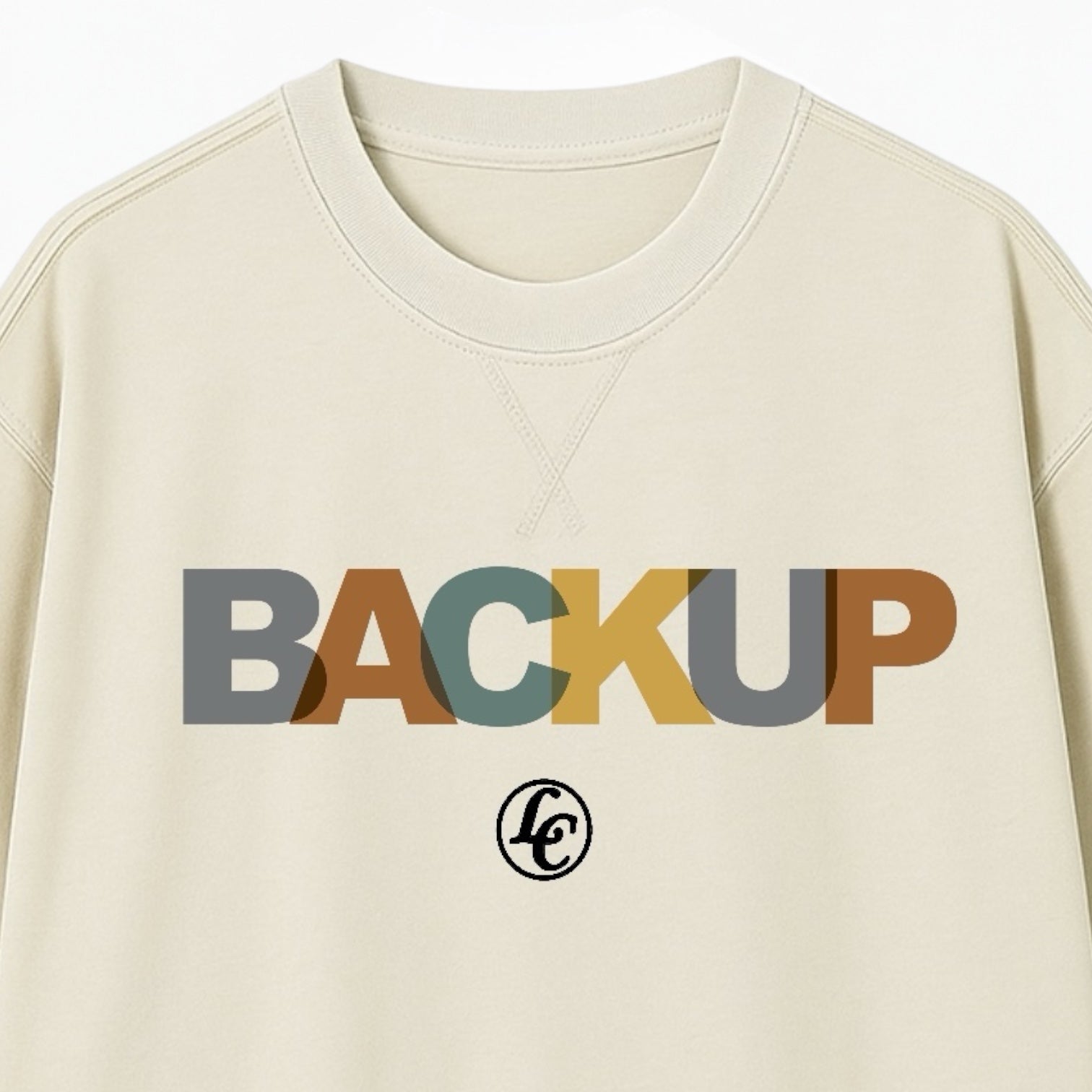 Beige sweatshirt with 'BACKUP' text in multicolor on a beige background